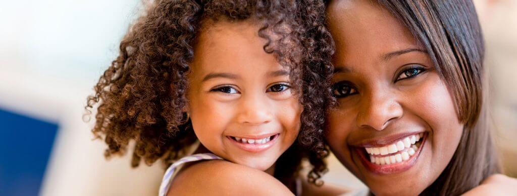 Stock image of a woman with a child smiling